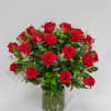 Red roses arranged in a clear glass vase