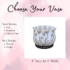 Decorative white ceramic vase with black floral pattern and scalloped rim