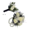 Creamy white spray roses and velvety navy ribbon give this wristlet corsage