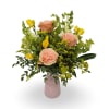Peach roses and bright yellow freesia make a fresh, cheerful statement in