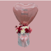A large pink heart-shaped "Happy Birthday" balloon rises above a compact hatbox