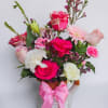 Bright, playful color takes center stage in this mixed flower arrangement-perfect as