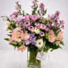 Mixed pink and purple bouquet in a clear glass vase