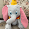 This gray plush with oversized pink ears and a bright yellow hat