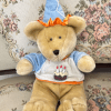 Soft beige teddy with blue party hat, birthday shirt with cake graphic