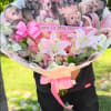 Pink bouquet with lilies, roses, and monkey cutouts