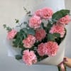 Bouquet of pink carnations with eucalyptus in white wrap