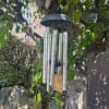 Wind chime hanging from a tree branch outdoors