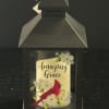 Black lantern with a cardinal and floral design reading "Amazing Grace"