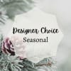 White tag reading Designer Choice Seasonal over pine branches and a pinecone