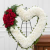 A timeless expression of love and remembrance, this elegant heart-shaped wreath is