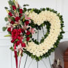 A stunning expression of everlasting love, this luxurious heart-shaped wreath is crafted