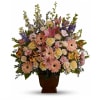Mixed bouquet of pink lilies, roses, and gerbera daisies in a brown vase