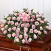 Pink rose casket spray with ribbon accents