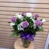 A rounded cluster of lavender and white roses creates an immediately soft