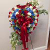This standing sympathy spray is a vibrant patriotic tribute featuring a dense