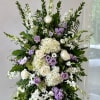 Large standing floral spray with white, lavender, and cream blooms