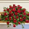 Large arrangement of red roses on a wooden table