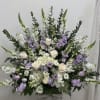 Large white and lavender floral arrangement in a vase