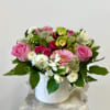 Pink and white mixed flower arrangement in a white vase