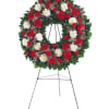 Red and white floral wreath on a standing easel