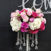 Pink and white rose arrangement on a tall stand with crystal strands