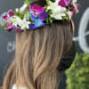 Flower crown with white and magenta orchids on a woman's head
