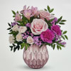 Pink and white flower arrangement in a textured pink vase