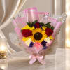 Bouquet of sunflowers, red roses, and mixed blooms wrapped in pink paper