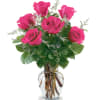 Pink roses arranged in a clear glass vase