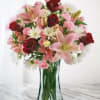 Bouquet of pink and red flowers in a clear glass vase