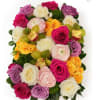 Round bouquet of multicolored roses with orchids and green accents