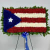 Floral standing display arranged like the Puerto Rico flag on an easel