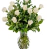 White roses arranged in a clear glass vase