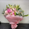 Pink bouquet with roses and lilies wrapped in pink paper