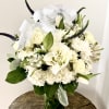 A white sympathy arrangement in a vase offers a timeless expression of