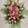 Large standing floral spray with pink roses and lilies on a tripod easel