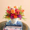 Flowers: free spirit roses, orange dahlias, orange waxflower, hot pink roses, green