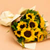 Approximately 10-12 sunflowers with greenery and seasonal accent flowers. 

Wrapped in brown
