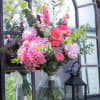 Pink mixed bouquet in a clear glass vase with eucalyptus
