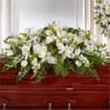 White floral casket spray with lilies and roses