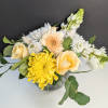 Yellow and white mixed flowers in a glass vase