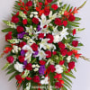 Large standing spray of red, white, and purple flowers