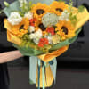 Bouquet of sunflowers, roses, and white blooms wrapped in yellow and green paper
