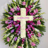 Large floral cross with pink, white, and purple flowers
