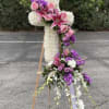 Tall floral standing spray with pink lilies, roses, and white blooms