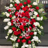 Standing floral spray with red and white roses and pink lilies
