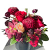 Bouquet of red and pink flowers in a black vase