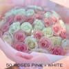 Bouquet of pink and white roses wrapped in pale pink paper