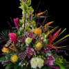 Tall green orchid sprays crown this dramatic tropical flower arrangement, the perfect
